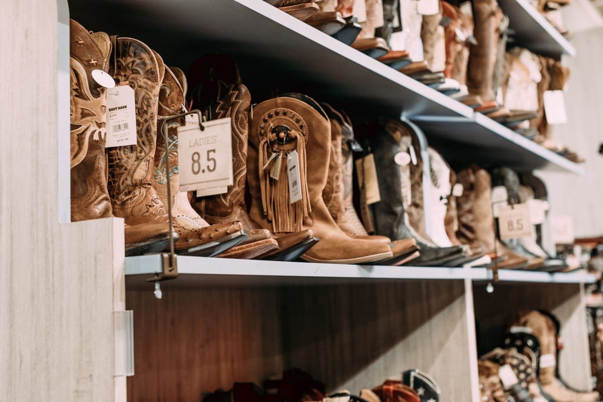 Cowboy boots lined up on shelves in a western store