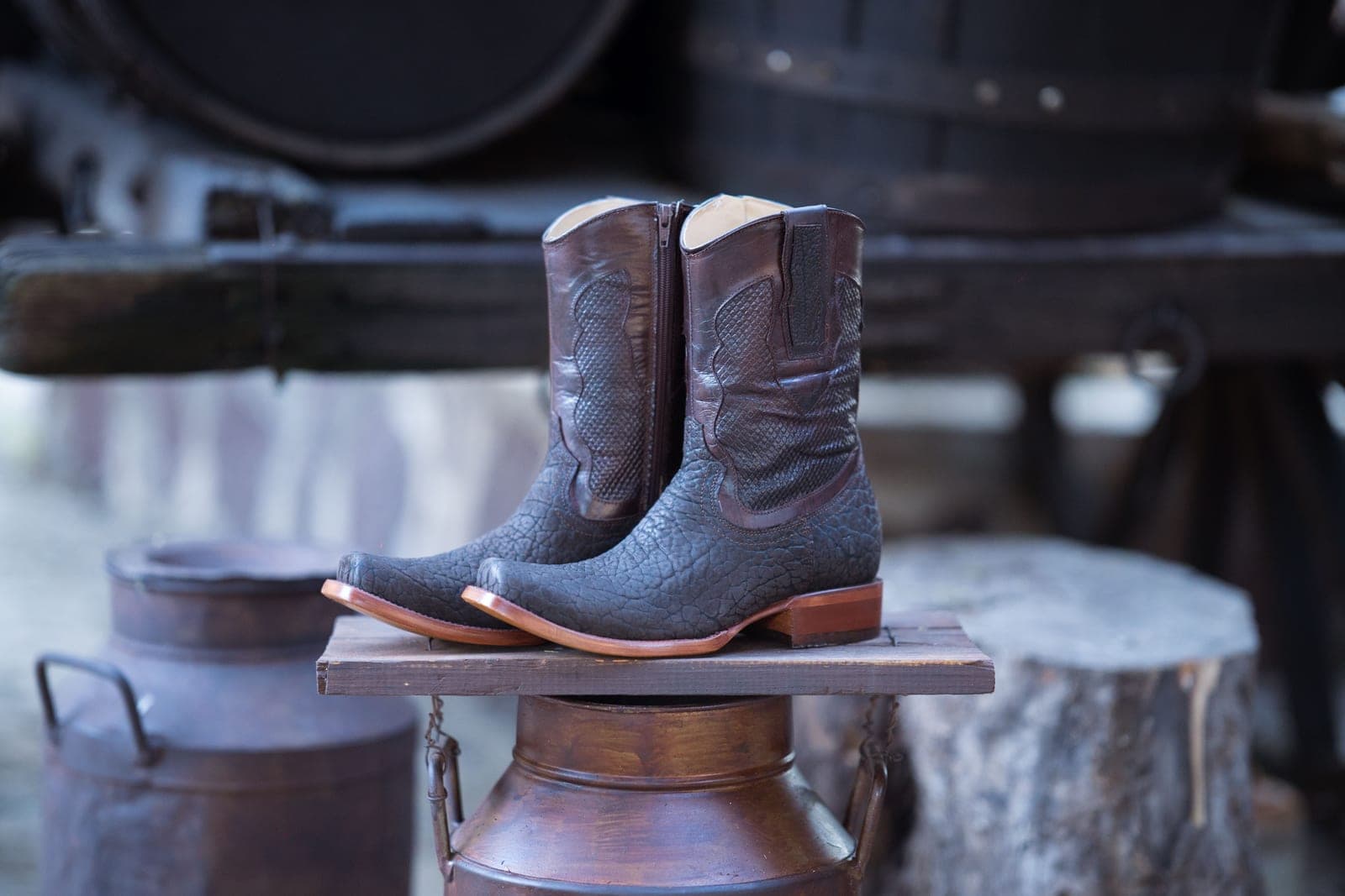 Leather cowboy boots photographed on a wooden surface