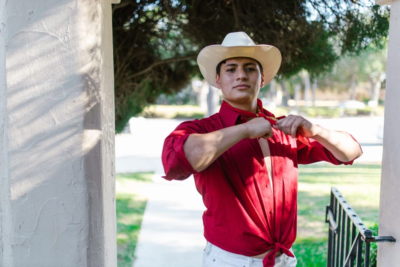 A man in a western shirt and hat